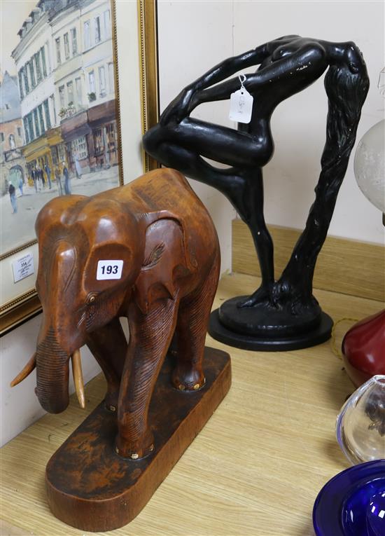 A plaster figure and a carved wood elephant